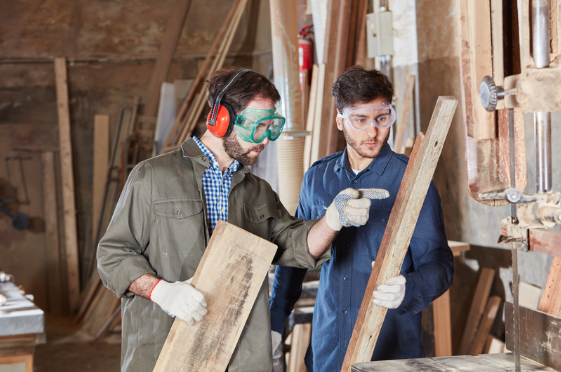 Two men working together on a construction site.